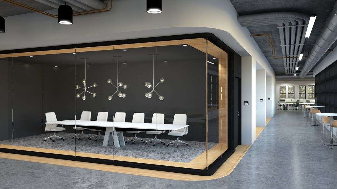 Long white conference table privately tucked away in an office pod.