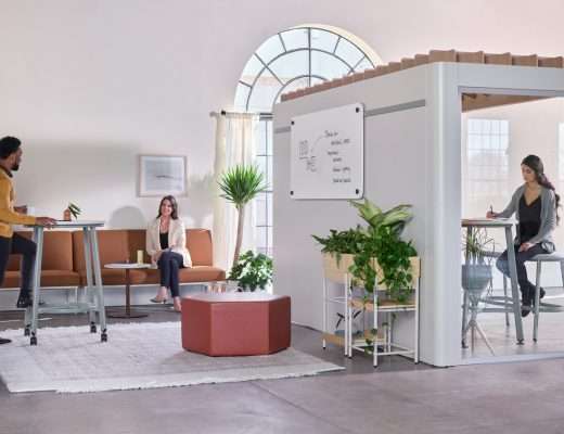 Modern office is broken into zones with cubicles in one area and a relaxed coworking space in another.